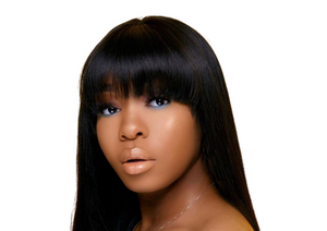 Close-up of a woman with sleek long hair and bangs, showcasing beautiful skin and makeup in a hair care collection.
