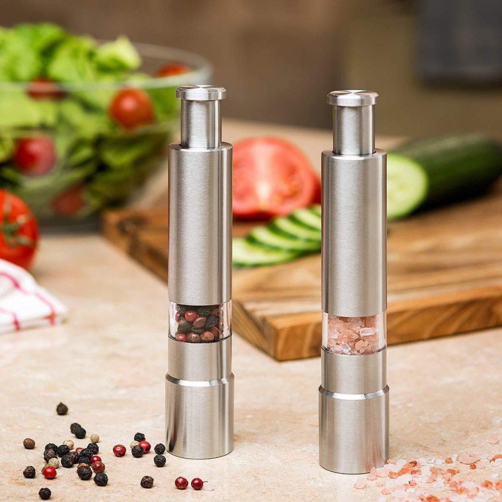 Premium stainless steel salt and pepper grinders for efficient spice dispensing in a kitchen setting.