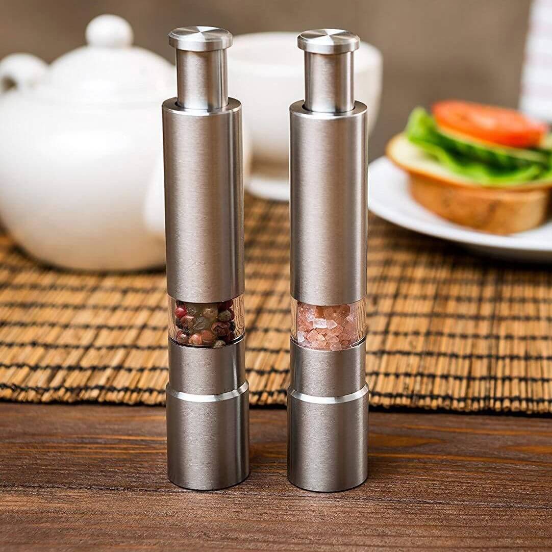 Premium stainless steel salt and pepper grinder set, featuring sleek design and transparent spice chambers.
